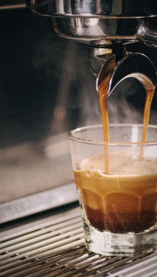 Vertical social ad: espresso extracting into a glass